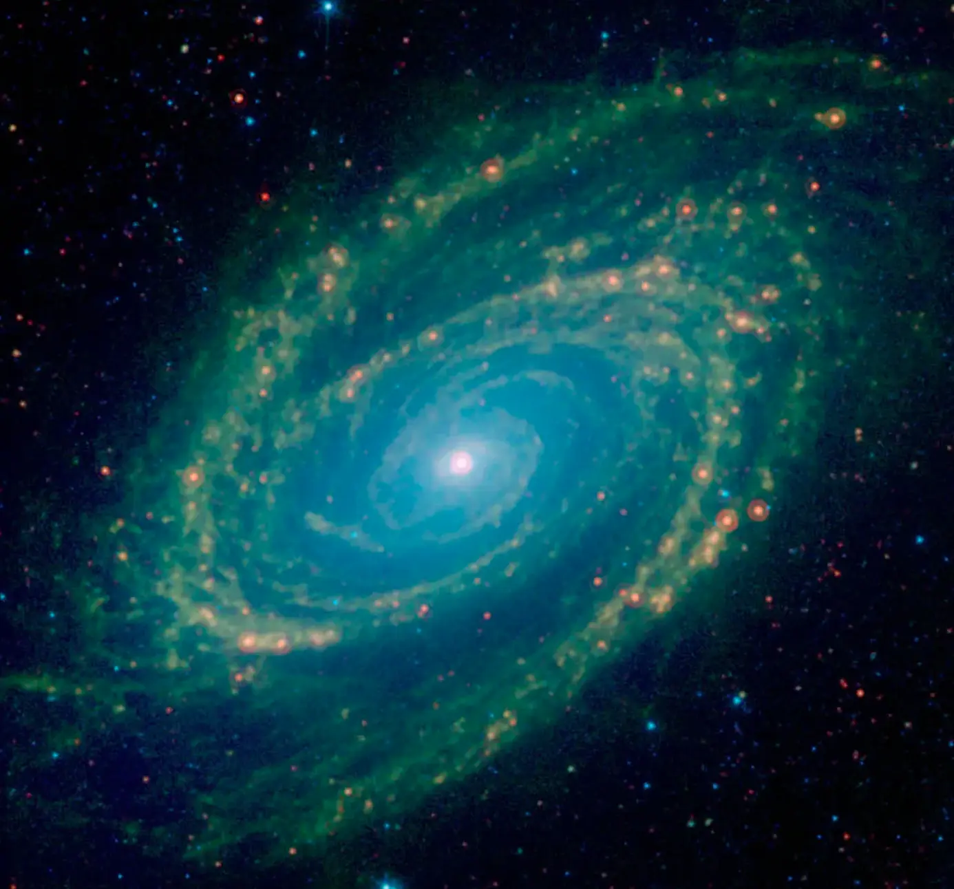 A galaxy revolves in dark space